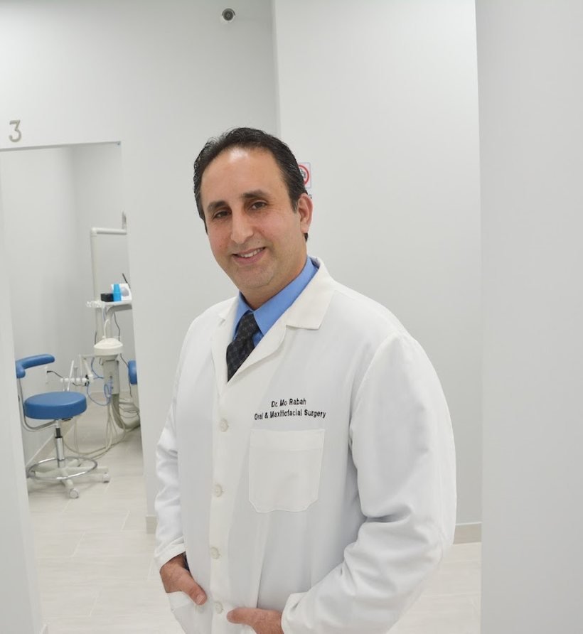 Dr. Mo Rabah, oral and maxillofacial surgeon, in a treatment room at Master Dentistry Center